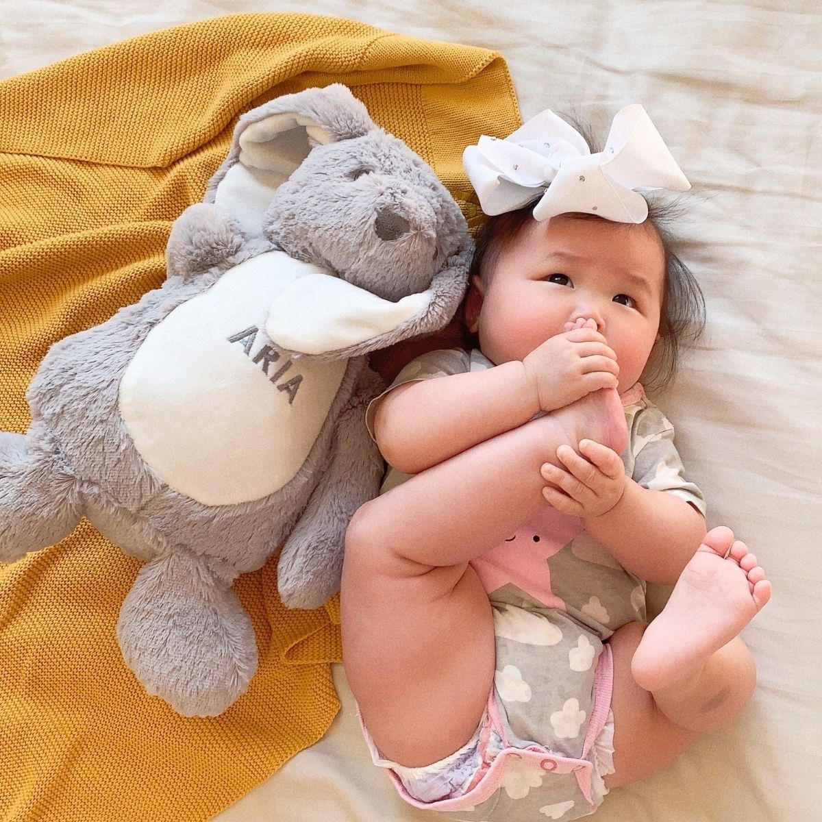 Aria with her personalised bear and mustard blanket bundle